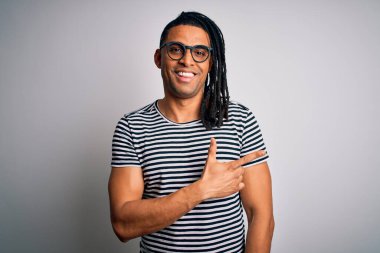 Çizgili tişört ve gözlüklü yakışıklı Afro-Amerikan bir adam. Yüzünde mutlu ve doğal bir ifade olan yüzü, eli ve parmağı yana dönük bir gülümseme.