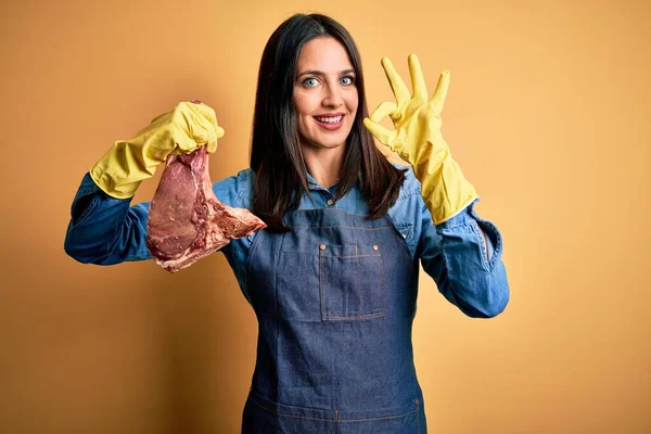 Young Butcher Woman Wearing Apron Holding Raw Beef Steak Yellow — Stock Photo, Image