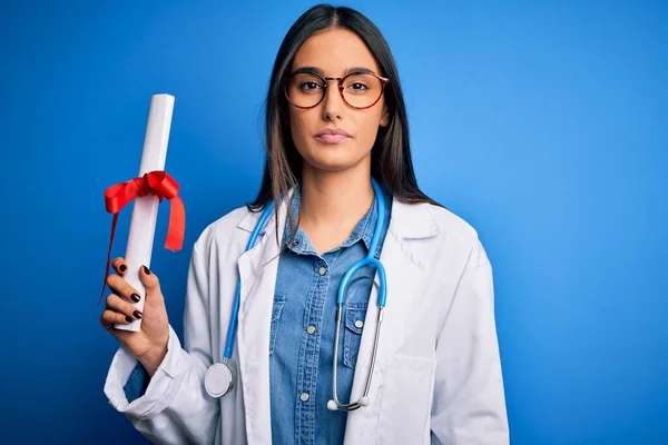 Young Beautiful Brunette Doctor Woman Wearing Glasses Coat Holding Diploma — Stock Photo, Image