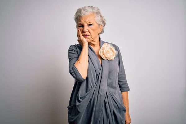 Senior beautiful grey-haired woman wearing casual dress standing over white background thinking looking tired and bored with depression problems with crossed arms.