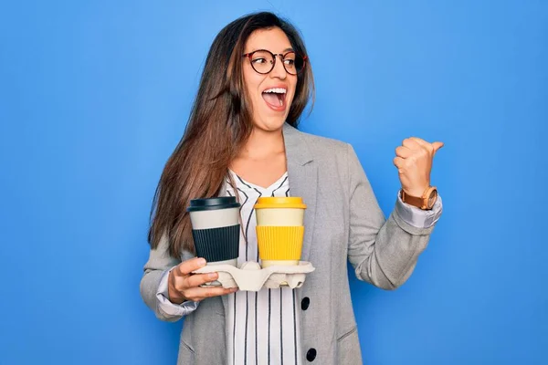 Ung Latinamerikansk Praktikant Affärskvinna Håller Kaffe Över Blå Bakgrund Pekar — Stockfoto