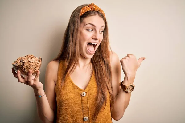 Young Beautiful Redhead Woman Holding Bowl Healthy Cornflakes Cereals Pointing — Stock Photo, Image