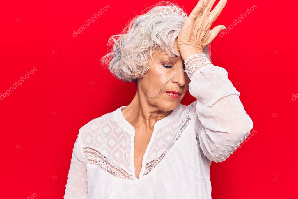Senior grey-haired woman wearing casual clothes surprised with hand on head for mistake, remember error. forgot, bad memory concept. 