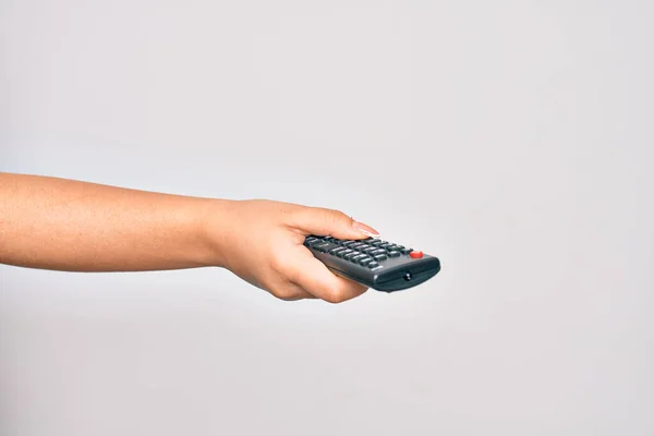 高加索女青年手拿着电视遥控装置改变电视频道对孤立的白色背景的控制 — 图库照片