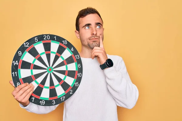 Young Handsome Man Blue Eyes Holding Dartboard Isolated Yellow Background — Stock Photo, Image