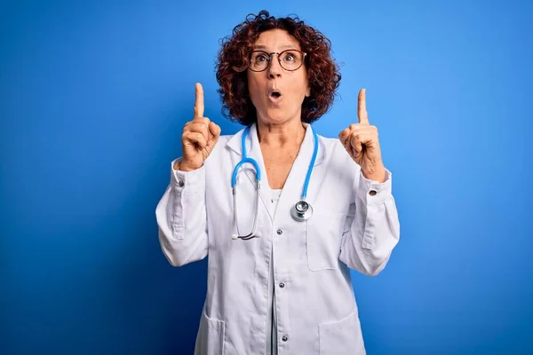 Orta Yaşlı Kıvırcık Saçlı Doktor Kadın Mavi Arka Planda Ceket — Stok fotoğraf