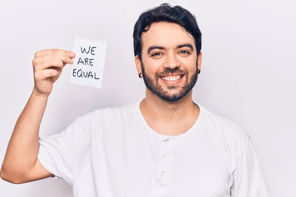 Young Hispanic Man Holding Equal Paper Looking Positive Happy Standing — Stock Photo, Image