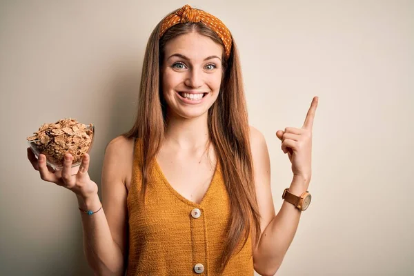 Young Beautiful Redhead Woman Holding Bowl Healthy Cornflakes Cereals Surprised — Stock Photo, Image