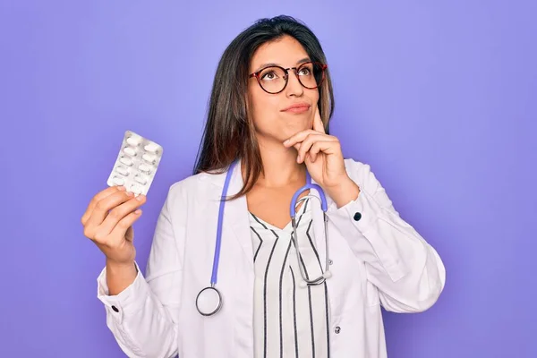 Junge Professionelle Ärztin Mit Pharmazeutischen Pillen Über Lila Hintergrund Ernstes — Stockfoto
