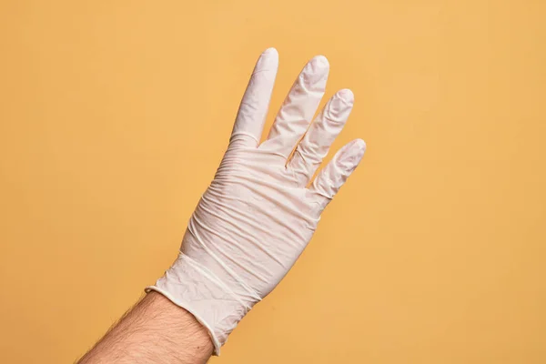 Hand Caucasian Young Man Medical Glove Isolated Yellow Background Counting — Stock Photo, Image