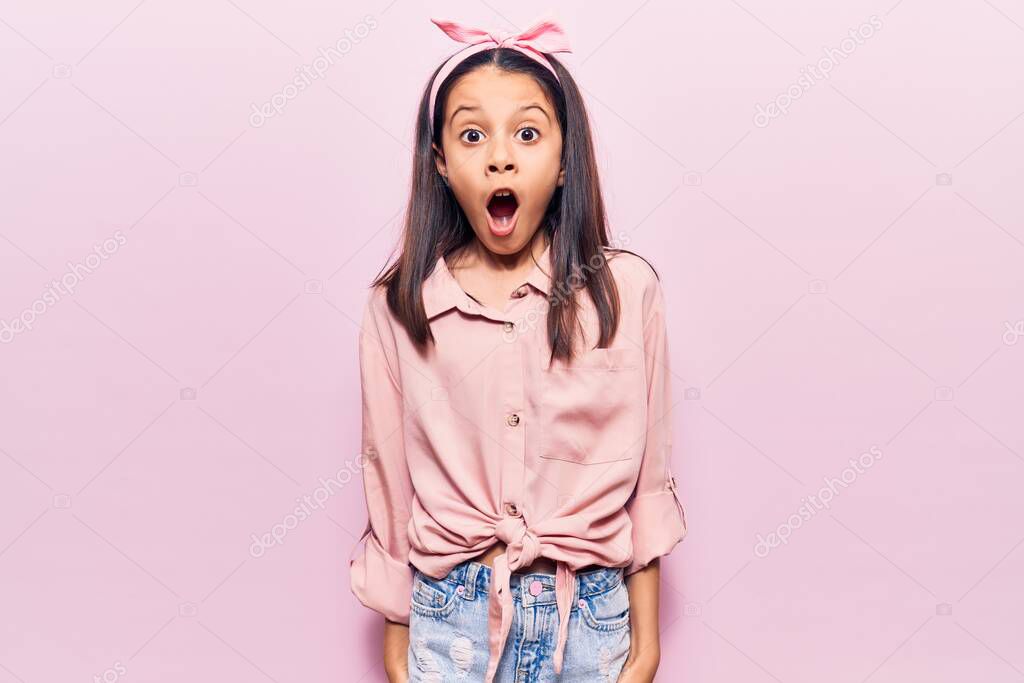 Beautiful child girl wearing casual clothes afraid and shocked with surprise and amazed expression, fear and excited face. 
