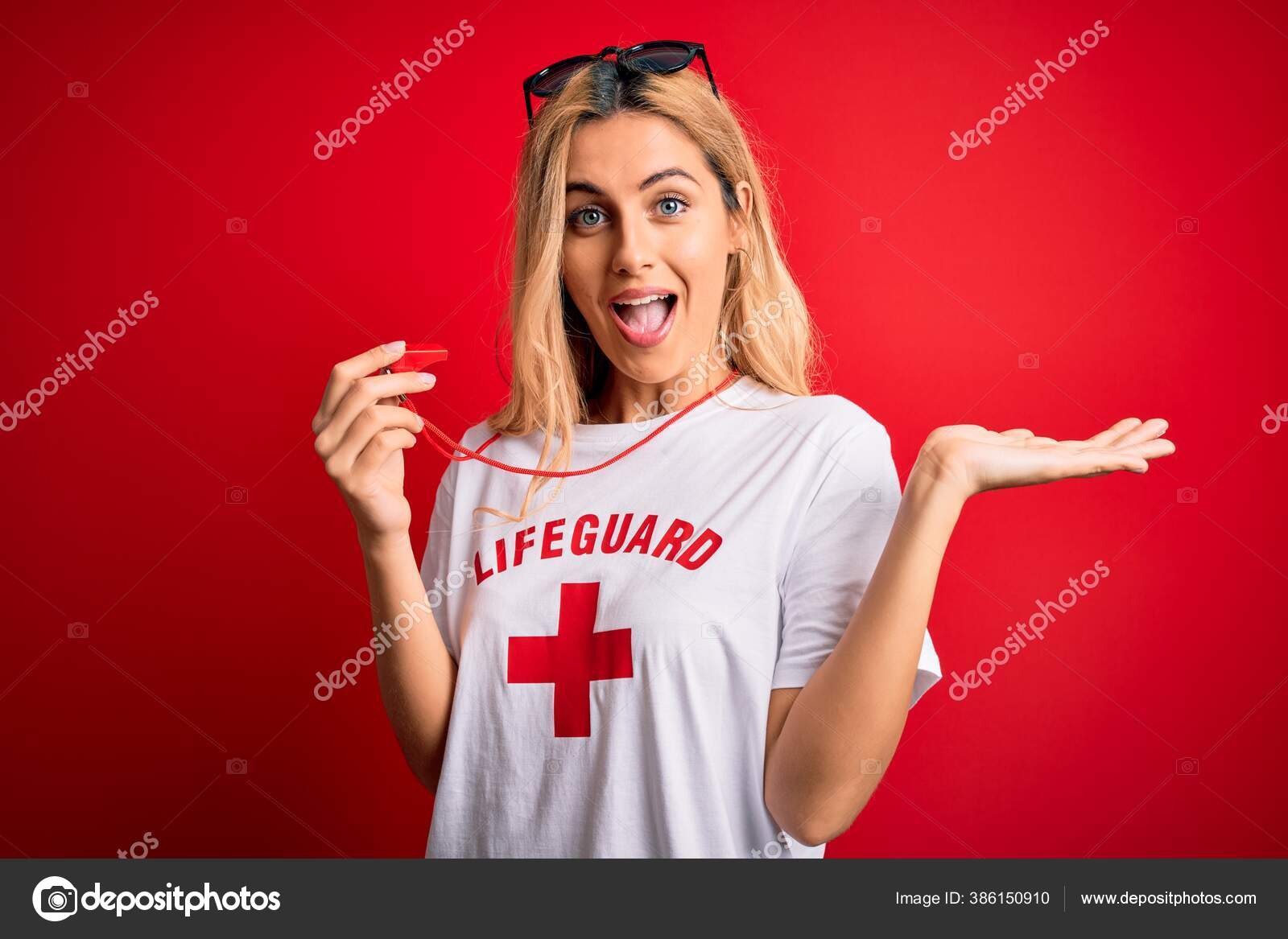 Young Beautiful Blonde Lifeguard Woman Wearing Shirt Red Cross Using