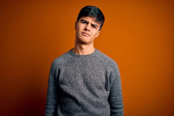 Jovem Homem Bonito Vestindo Camisola Casual Sobre Fundo Laranja Isolado — Fotografia de Stock