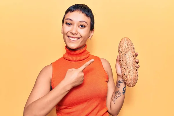 Young Woman Holding Wholemeal Bread Smiling Happy Pointing Hand Finger — Stock Photo, Image