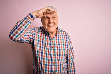 Üst düzey yakışıklı beyaz adam, pembe arka planda günlük bir tişört giyiyor. Çok mutlu ve gülümsüyor. Çok uzaklara bakıyor. Konsept aranıyor.