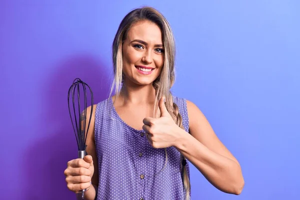 Young Beautiful Blonde Woman Cooking Holding Whisk Isolated Purple Background — Stock Photo, Image