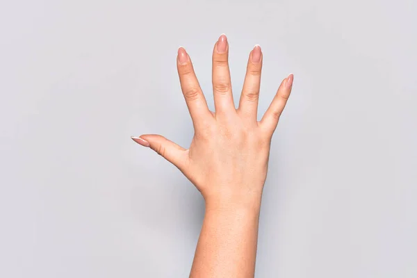 Hand of caucasian young woman counting number 5 showing five fingers
