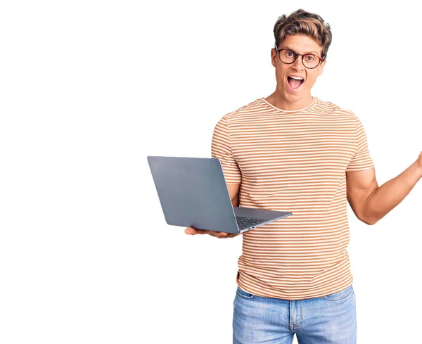 Молодий Красивий Чоловік Окулярах Тримає Ноутбук Святкуючи Перемогу Щасливою Посмішкою — стокове фото