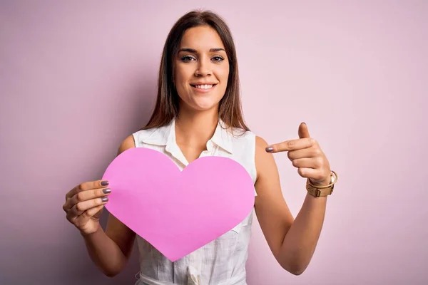 Young Beautiful Brunette Woman Holding Big Pink Heart Paper Celebrating — Stock Photo, Image