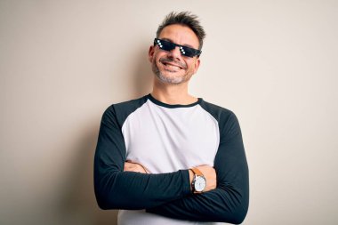 Young handsome man wearing funny thug life sunglasses meme over white background happy face smiling with crossed arms looking at the camera. Positive person. clipart