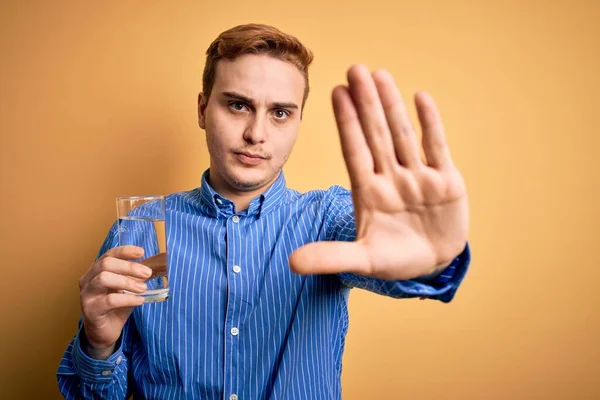 Ung Stilig Rödhårig Man Dricka Glas Vatten Över Isolerad Gul — Stockfoto