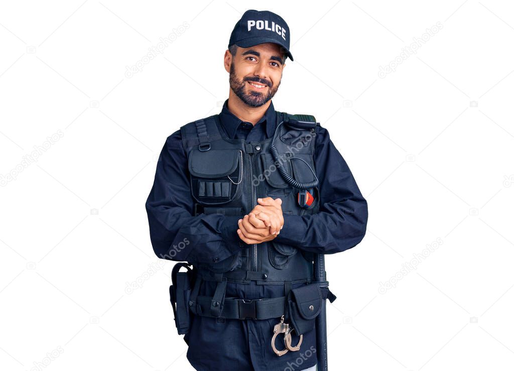 Young hispanic man wearing police uniform with hands together and crossed fingers smiling relaxed and cheerful. success and optimistic 