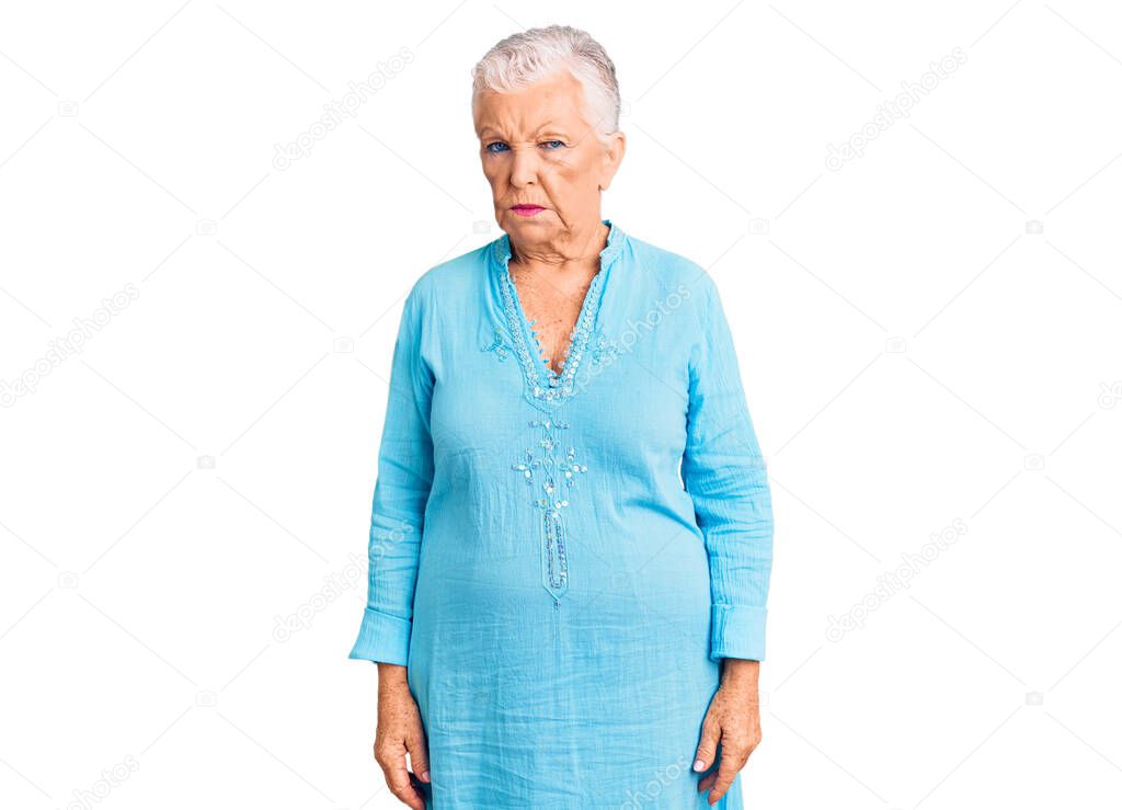 Senior beautiful woman with blue eyes and grey hair wearing summer dress skeptic and nervous, frowning upset because of problem. negative person. 