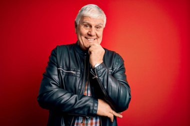 Kıdemli yakışıklı, beyaz gömlekli ve ceketli, izole edilmiş kırmızı arka planda gülümseyen, kolları çapraz ve çenesi havada bir adam. Olumlu düşünüyorum..