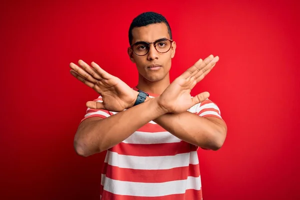 잘생긴 아프리카 미국인 남자는 줄무늬 티셔츠와 표정으로 손바닥을 교차하는 부정적 — 스톡 사진