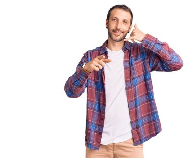 Gülümseyen gündelik kıyafetler giyen genç yakışıklı adam telefonda konuşuyor ve seni işaret ediyor. Ara beni.. 