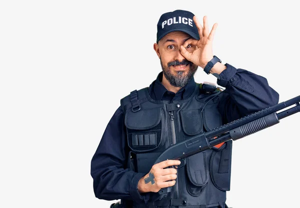 Młody Przystojny Mężczyzna Mając Sobie Policyjny Mundur Trzymając Shotgun Uśmiechając — Zdjęcie stockowe