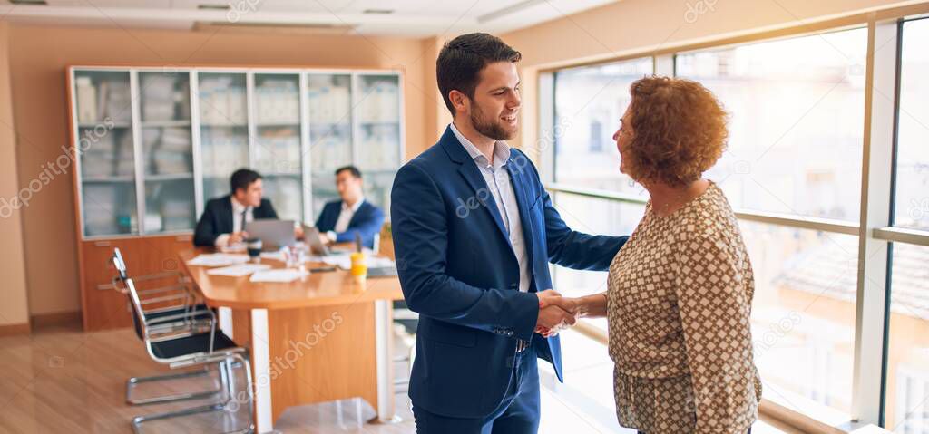 Business lawyers workers meeting at law firm office. Professional executive partners working on finance strategry at the workplace. Shaking hands for succesful agreement.