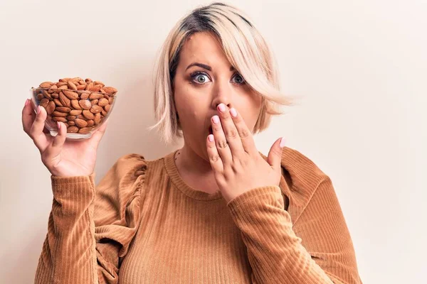 Young Beautiful Size Woman Holding Bowl Healthy Almonds White Background — Stock Photo, Image