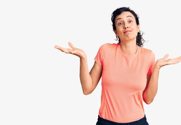 Young Beautiful Hispanic Woman Wearing Sportswear Clueless Confused Expression Arms — Stock Photo, Image