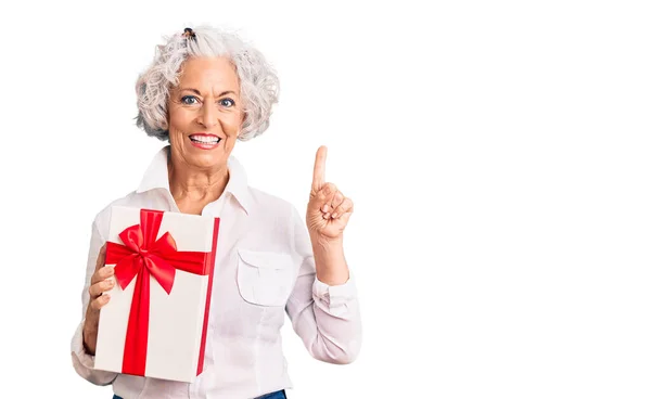 Senior Grey Haired Woman Holding Gift Surprised Idea Question Pointing — Stock Photo, Image