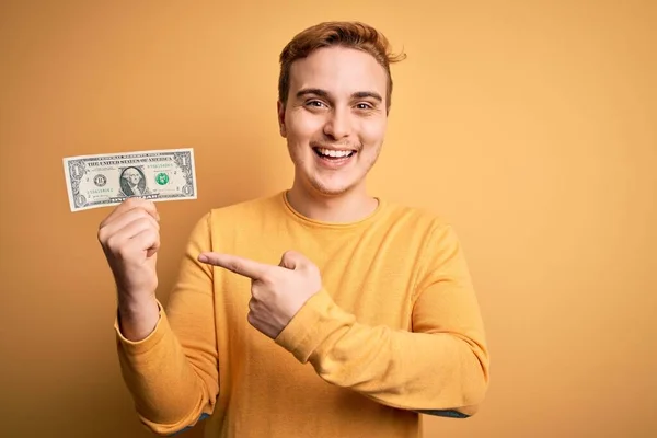 Young Handsome Redhead Man Holding One Dollar Banknotes Isolated Yellow — Stock Photo, Image