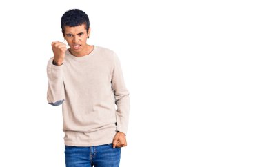 Genç Afro-Amerikalı bir adam günlük kıyafetler giyiyor kızgın ve kızgın yumruğunu kaldırıyor ve öfkeyle bağırıyor. öfke ve agresif konsept. 