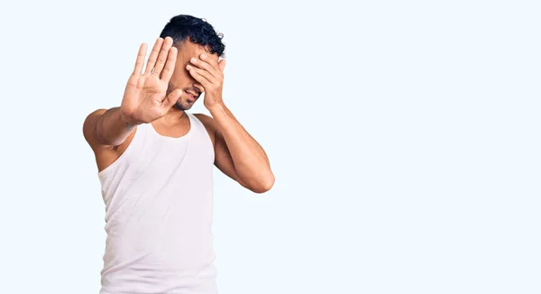 Young Hispanic Man Wearing Casual Clothes Covering Eyes Hands Doing — Stock Photo, Image