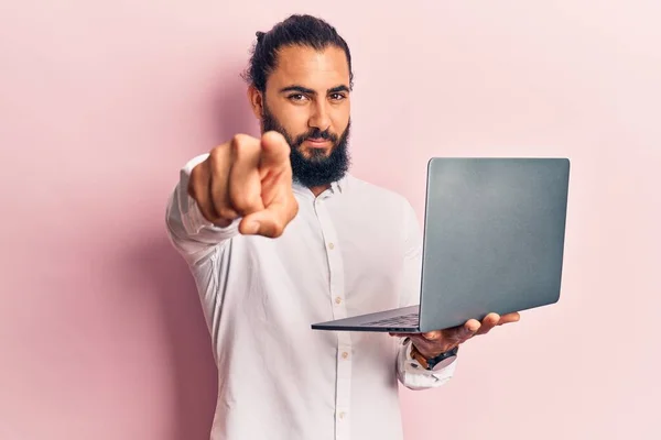 Młody Arabski Mężczyzna Trzymający Laptopa Wskazując Palcem Kamerę Ciebie Pewny — Zdjęcie stockowe