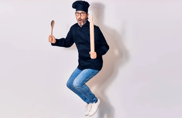 Middle Age Handsome Hispanic Man Surprised Wearing Glasses Cook Uniform — Stock Photo, Image