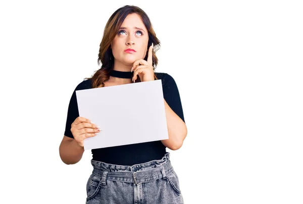 Young Beautiful Caucasian Woman Holding Blank Empty Paper Serious Face — Stock Photo, Image