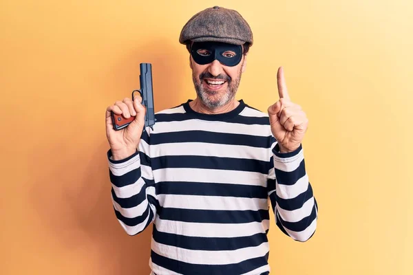 Middle Age Handsome Burglar Man Wearing Cap Mask Holding Gun — Stock Photo, Image