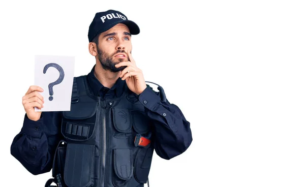 Νεαρός Όμορφος Άνδρας Γενειάδα Φορώντας Αστυνομική Στολή Κρατώντας Ερωτηματικό Σοβαρό — Φωτογραφία Αρχείου