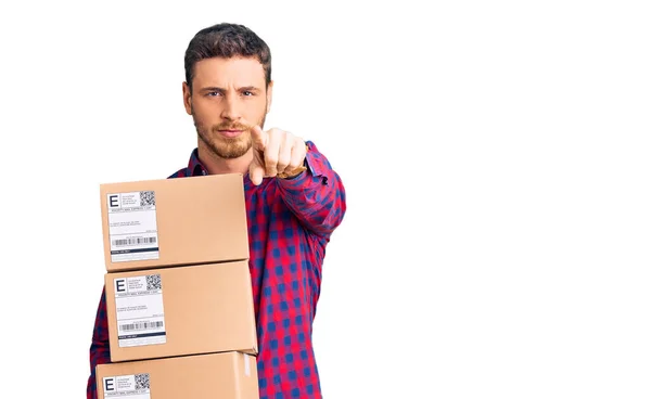 Handsome Young Man Bear Holding Delivery Packages Pointing Finger Camera — Stock Photo, Image