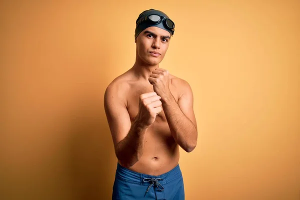 Young Handsome Man Shirtless Wearing Swimsuit Swim Cap Isolated Yellow — Stock Photo, Image