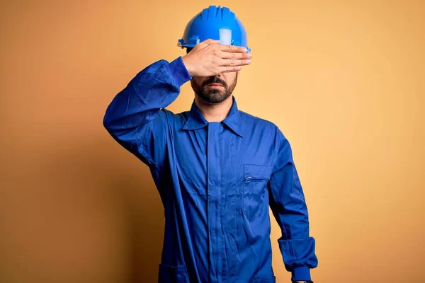 Mechanic Man Beard Wearing Blue Uniform Safety Helmet Yellow Background — Stock Photo, Image