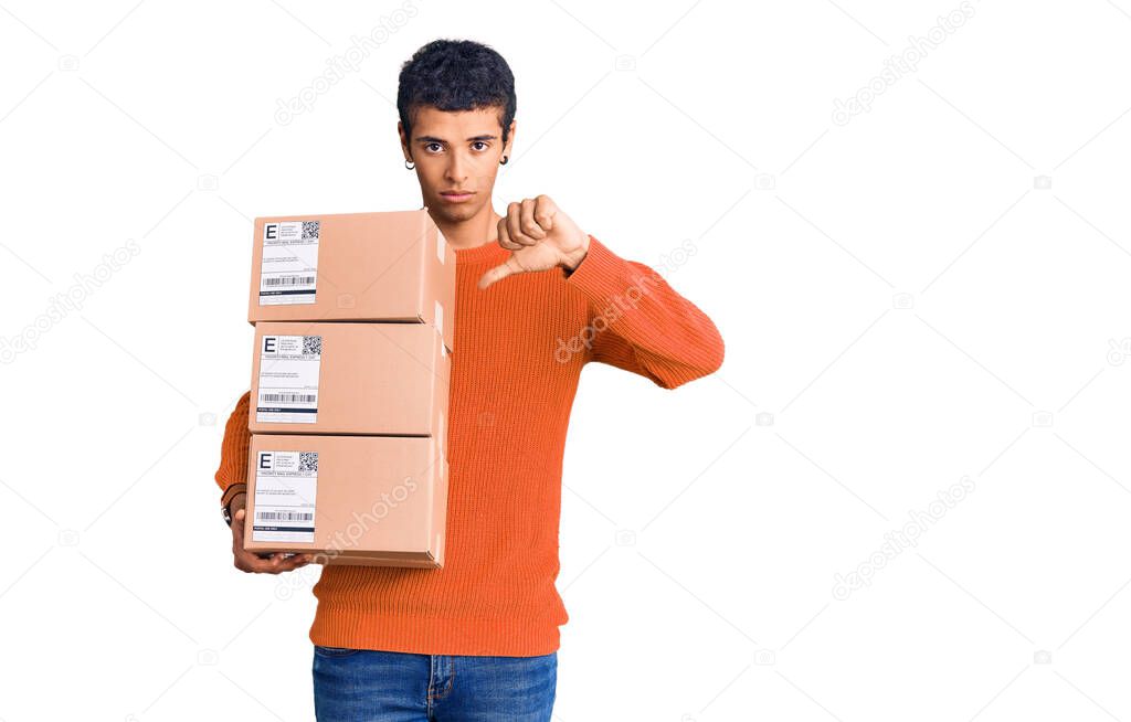 Young african amercian man holding delivery package with angry face, negative sign showing dislike with thumbs down, rejection concept 