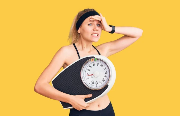 Young Beautiful Blonde Woman Wearing Sportswear Holding Weighing Machine Stressed — Stock Photo, Image