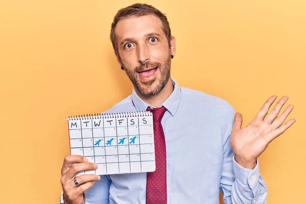 Young Handsome Man Holding Travel Calendar Celebrating Achievement Happy Smile — Stock Photo, Image