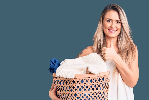 Young Beautiful Blonde Woman Holding Laundry Basket Smiling Happy Positive — Stock Photo, Image